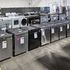 Rows of washers, dryers, and dishwashers on the showroom floor